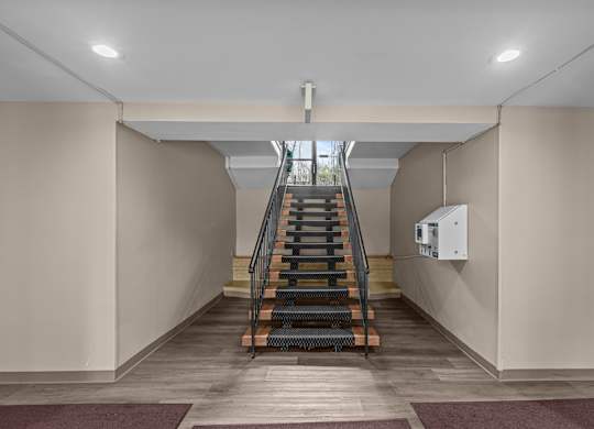 A staircase with a metal railing at Kensington House, Kensington, Maryland