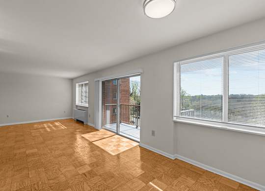 A room with a sliding glass door leading to a balcony at Kensington House, Maryland 20895