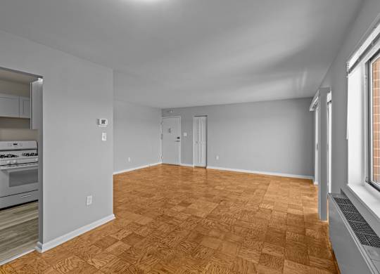 A room with wooden flooring and white walls at Kensington House, Kensington, MD 20895