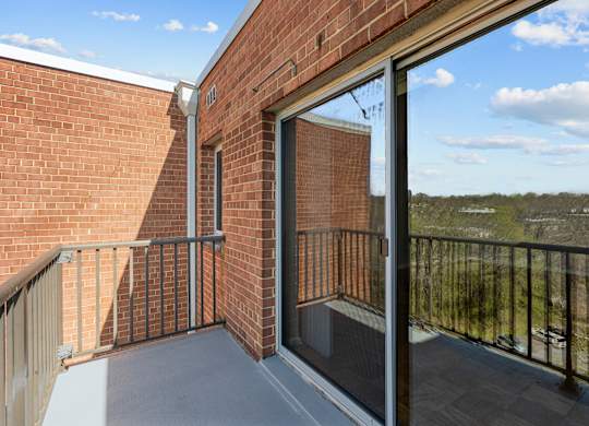 A balcony with a glass door at Kensington House, Kensington, 20895