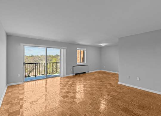 A room with wooden flooring and a balcony with a railing at Kensington House, Kensington, Maryland