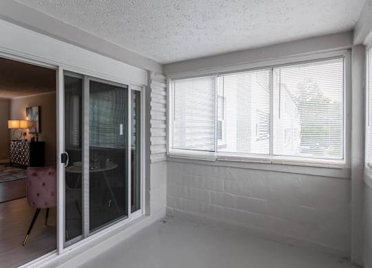 A room with a sliding glass door leading to a balcony at The Lawrence Apartments, Greenbelt, MD 20770