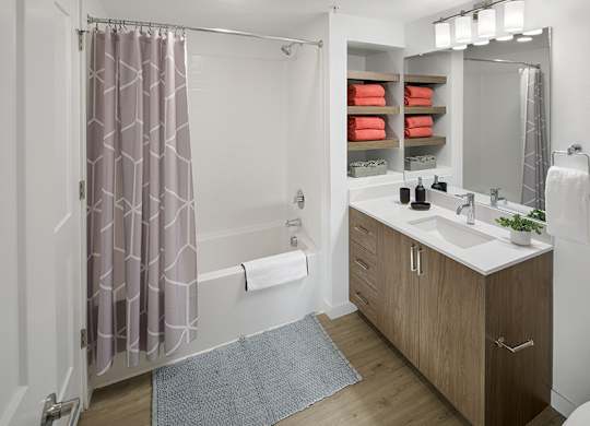 Modern bathrooms include soaking tubs with tile surround and built-in shelving
