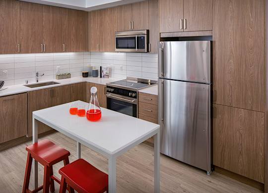Our kitchens feature stainless steel appliances, tile backsplash and wood-grain cabinets