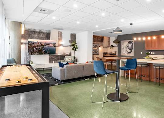 A modern kitchen with a dining table and chairs.