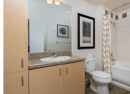 A bathroom with a white toilet, sink, and bathtub.