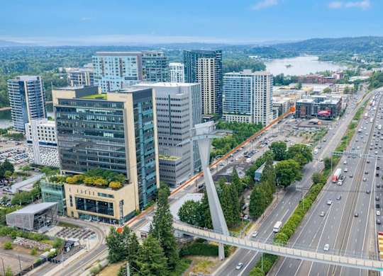 A cityscape with a highway and buildings.