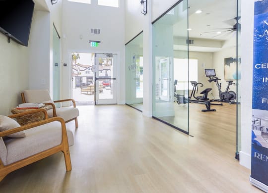 a waiting room at a hospital with chairs and glass doors