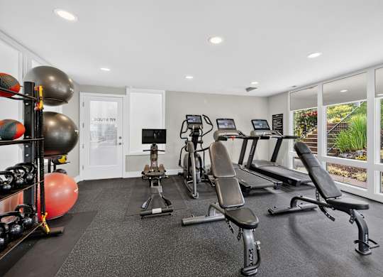 A well-equipped home gym with a variety of exercise equipment.