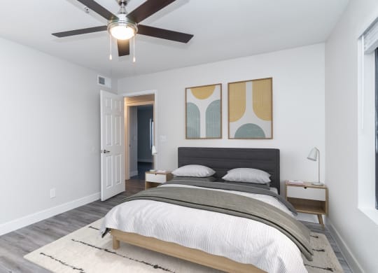 a bedroom with a large bed and a ceiling fan