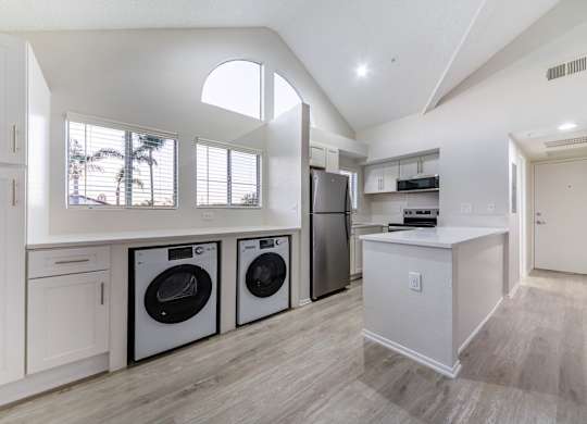 A modern laundry room with a washer and dryer in it.