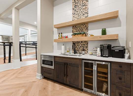 A kitchen with a wooden floor and a white wall.