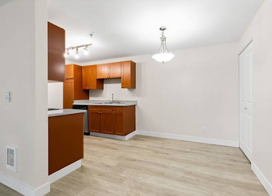 A kitchen with brown cabinets and a white countertop.