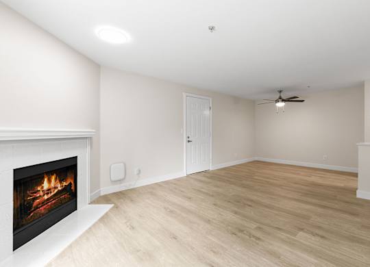 A room with a fireplace and a ceiling fan.