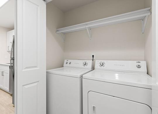 A white laundry room with a washer and dryer.