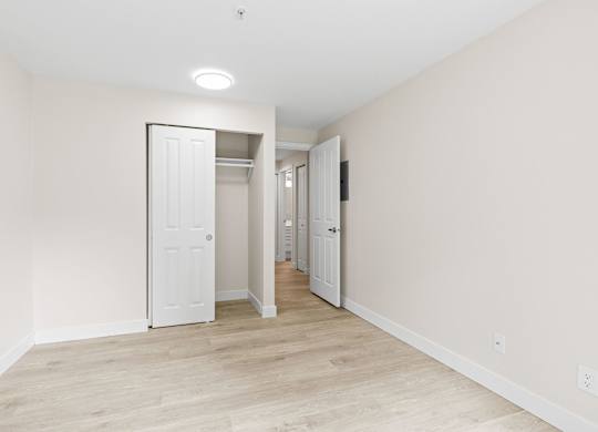 A white door is in the middle of a hallway.