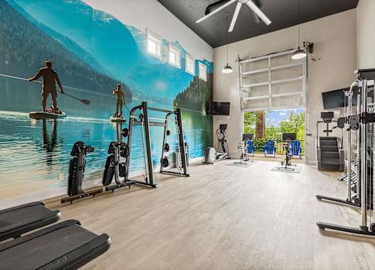 A gym with a large mural of people kayaking on a lake.