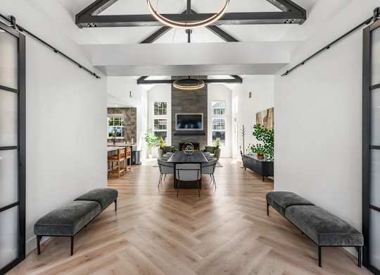 A modern living room with a wooden floor and a large window.