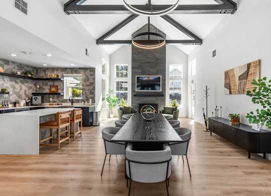 A modern dining room with a large table and chairs.