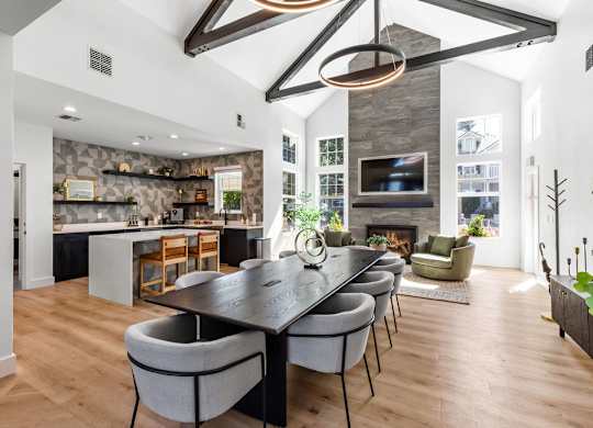 A modern dining room with a large table and chairs.