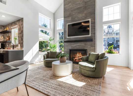 A living room with a fireplace and a television above it.