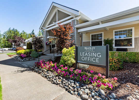 A Bradley Leasing Office is surrounded by flowers and greenery.