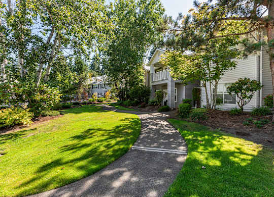 A residential area with a pathway and greenery.