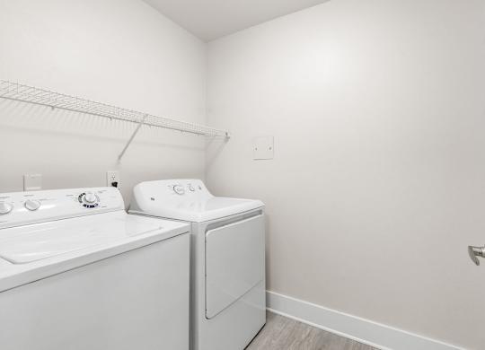 A white washer and dryer in a small laundry room.
