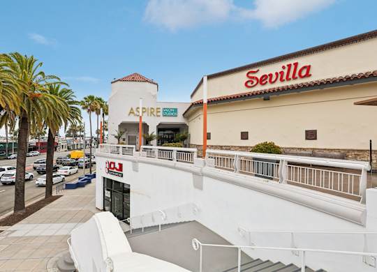A white building with a red sign that says Sevilla.