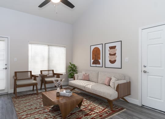 a living room with two windows and a ceiling fan
