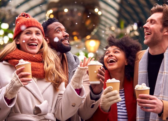 group of people drinking coffee at a holiday party