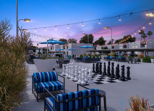 a giant chess board is set up on a patio