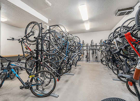 A bike parking room with many bikes.