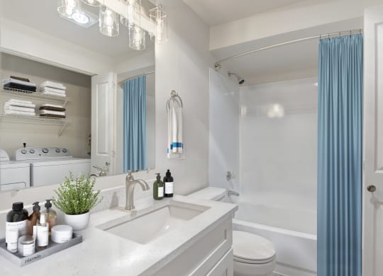 a bathroom with white walls and a blue shower curtain