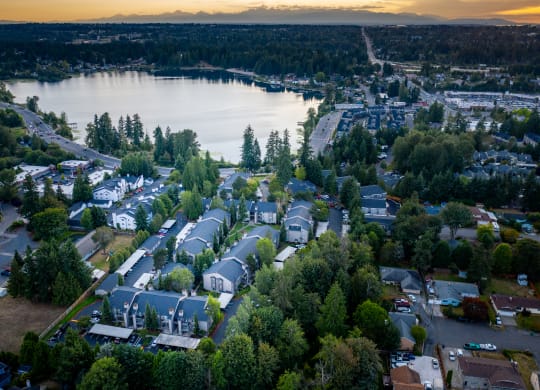 arial view of a neighborhood with a lake in the background