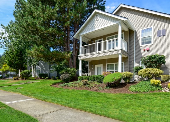 a house with a porch and a sidewalk in front of it