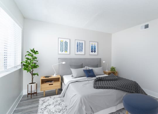 a bedroom with a bed and a chair in a 555 waverly unit