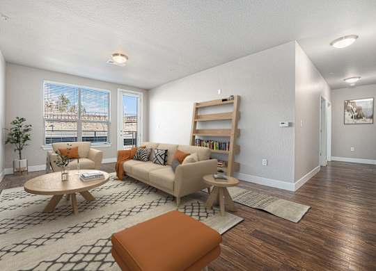 A living room with a couch, a chair, a coffee table, and a rug.