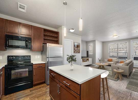 A modern kitchen with dark wood cabinets and a white island.