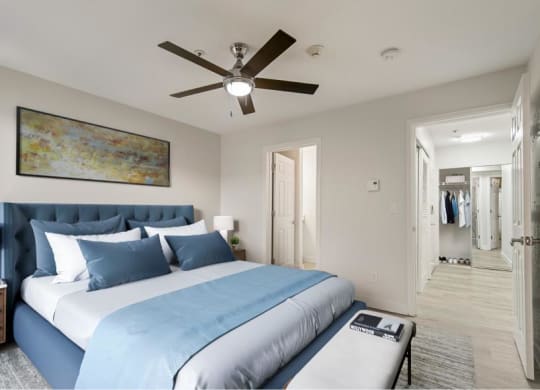 a bedroom with a large bed and a ceiling fan