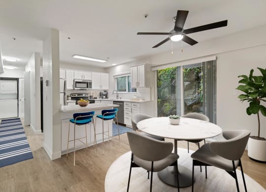 an open kitchen and dining area with a table and chairs