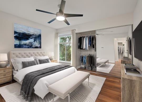 a bedroom with a bed and a ceiling fan