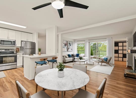 an open living room and kitchen with a table and chairs