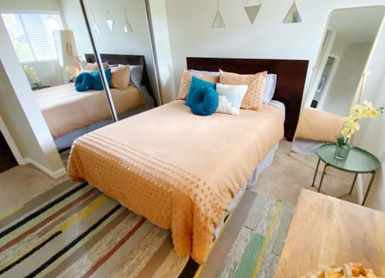a bedroom with a bed and a mirror
