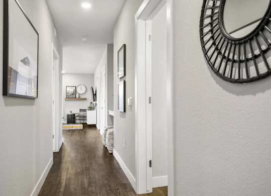 A long hallway with a mirror on the wall.