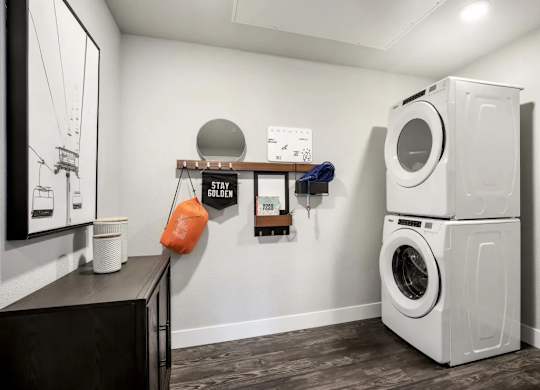 A washing machine is stacked on top of another in a laundry room.