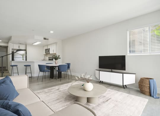 a living room with white walls and a white couch