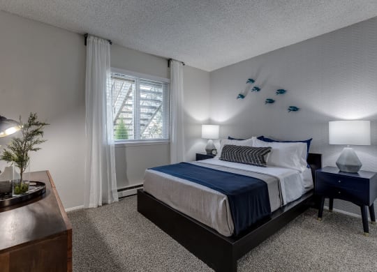 a bedroom with a bed and a window