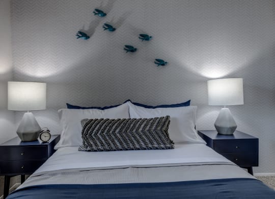 a bedroom with a bed and two night stands with lamps