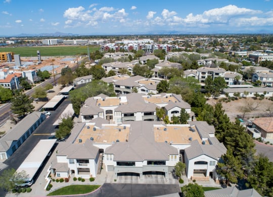an aerial view of a large suburban neighborhood with green grass and trees
